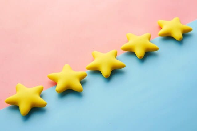 5 yellow stars on pink and blue background