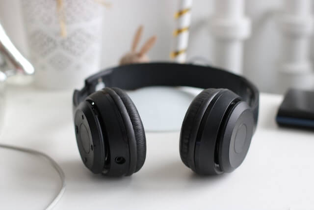 Black headphones laying on white desk