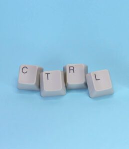 Singular keyboard buttons on blue background that spell CTRL